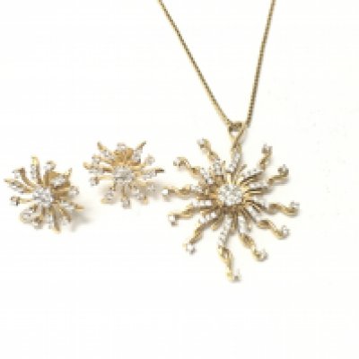 An 18ct diamond set pendant on 18ct gold chain with matching 18ct diamond set earrings. 19.48gPostage B