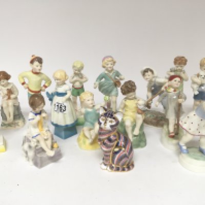 A collection of Royal Worcester Child figures fourteen figures designed by F Doughty. and Royal Crown Derby porcelain cat. No obvious damage. (15)