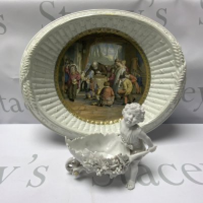 A Victorian Prattware Bread dish together with a continental porcelain figure of a boy with a wheelbarrow.