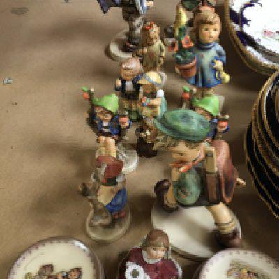 A collection of Hummel figures and small collectors plates no obvious damage.