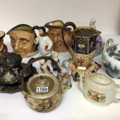 A collection of ceramics a Russian figure Doulton caricature jugs tea pots and other ornaments.