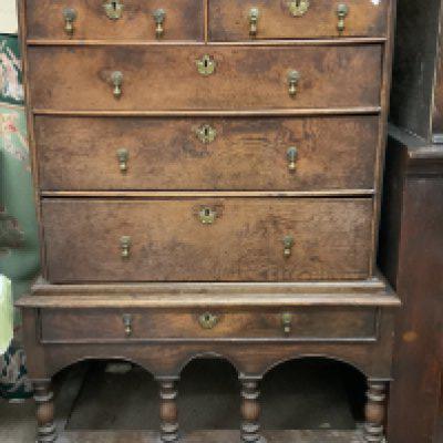 An early 18th century oak chest on later stand from the Queen Anne period. 103cm x 137.5cm x 62cm