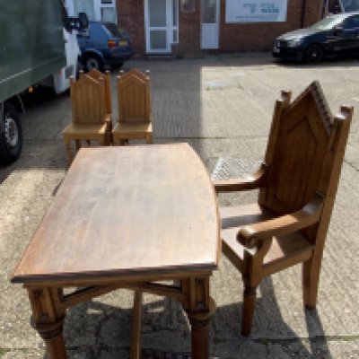 A 1920s solid oak ecclesiastical design church desk and matching armchair. With a brass applied dedication to stretched reading- 1914-18 IN LOVING MEMORY OF OUR BOYS WHO FELL IN THE GREAT WAR AND TO THE HONOUR AND GLORY OF THE PRINCE OF PEACE JANUARY 27 1923. THIS TABLE IS DEDICATED BY THEIR PARENTS. Desk: 138cm x 79cm x 77cm, Chair: 130cm x 56cm x 66cm