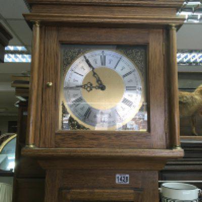 An oak long cased clock with a brass dial and visible weights. NO RESERVE