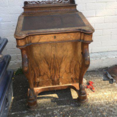 A Victorian walnut Davenport fitted with four side drawers.