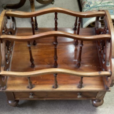A Victorian walnut Canterbury with lyre form fretwork sides.