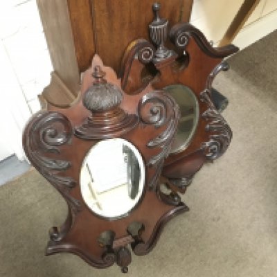 A pair of Victorian mirrors with carved design, 70cm tall approximately. This lot cannot be posted