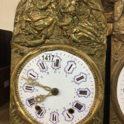 Two continental brass wall clocks with raised figures the enamel dial With Roman numerals with pendulums.