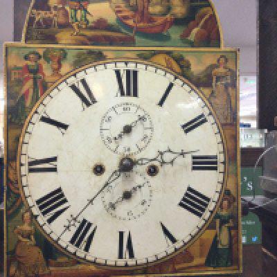 A oak long case clock the arched painted dial with Roman numerals.