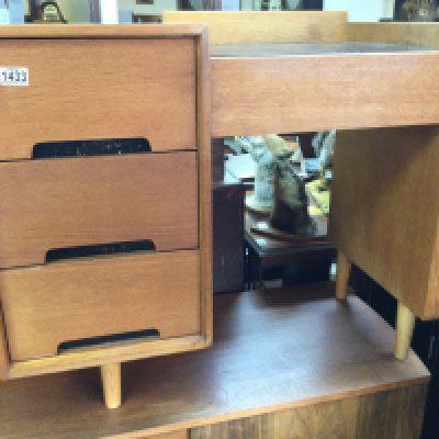 A small teak kneehole desk fitted with three drawers on turned legs . 45 cm x 88 cm