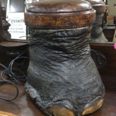 An elephant foot stool inset with a leather top. Shipping category D.
