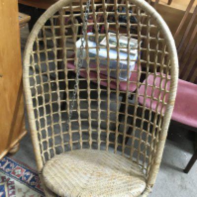A 1970s hanging rattan egg chair. Shipping category D.
