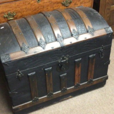 A quality Victorian dome top travelling trunk with wood and metal bound over leather.