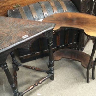 An Edwardian rosewood occasional table with a shaped top on splayed legs United by an under-tier and a carved oak occasional table (2)