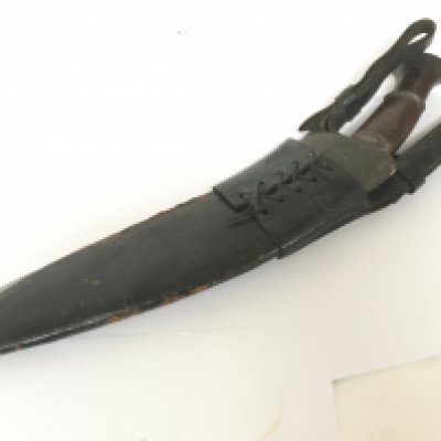 An old Kukri knife with leather scabbard.