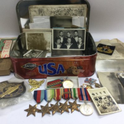 A tin of WWII ephemera comprising medals, photographs etc. Shipping category B.