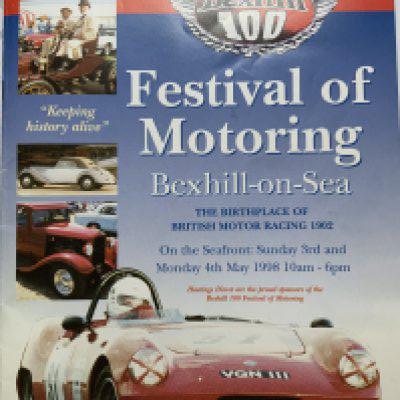 A Festival of Motoring Bexhill 100 brochure with an image signed by Sir Stirling moos on the inside cover.