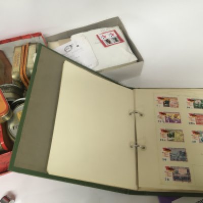 A collection of world stamps in tins and envelopes mainly used and second half of the 20th century and a green album of stamps. NO RESERVE