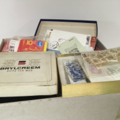 A box containing used world stamps in small boxes and including unused Elizabeth II stamp books and others a mixed lot.