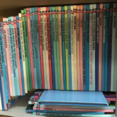 A box containing annuals Beno Dandy Match and others mainly early 2000 and a set of Disney books a comprehensive collection. and a die cast tractor