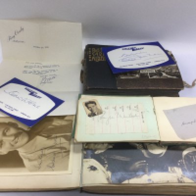 Two autograph booklets and a vintage postcard album. Names include Laurence Olivier, David Niven, Humphrey Bogart, Ronald Reagan and many more. Shipping category B.
