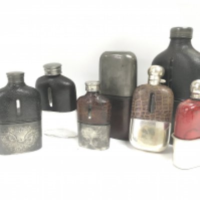 Vintage hip flasks, one with engraved design on the base and one with a flip up lid. This lot cannot be posted