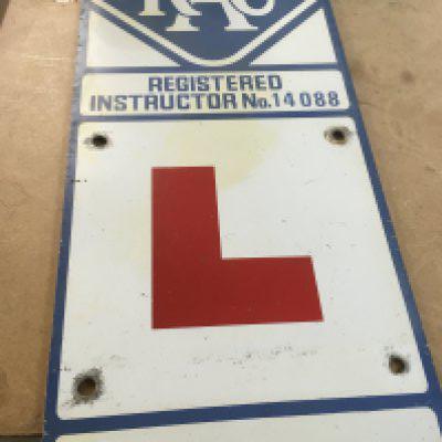 Vintage enamelled RAC instructors L plate. Postage category C
