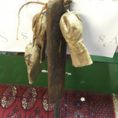 A vintage cricket bat and three early golf club head covers