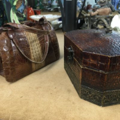 A leather carrying box with brass animal handle and vintage crocodile bag