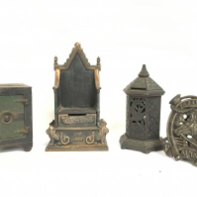 A collection of vintage cast iron money boxes including a Tally Ho Bank horse shoe, Coronation throne by Harper etc. Postage category C. NO RESERVE