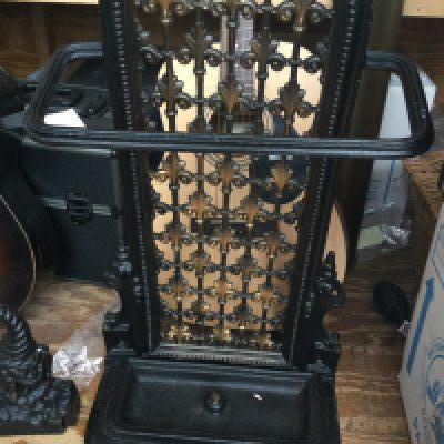 A cast iron stick stand and door stop .