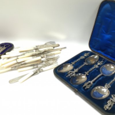 A collection of silver plated cutlery including knives, forks and a cased set of spoons. Postage category c