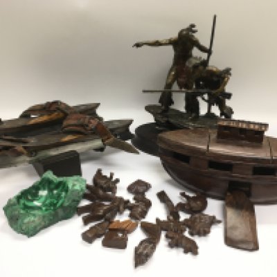 A collection of oddments comprising a bronzed figural group of native Americans, a carved wooden ark and animals, a polished sample of malachite and a pair of vintage skates.