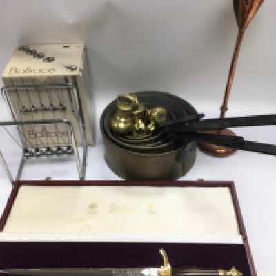 A collection of items comprising a set of brass weights, preserve pans, a Boxed Newton's cradle etc. Shipping category D.
