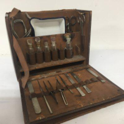 A Vintage leather surgeon case fitted with medical instruments and a Vintage typewriter and a typewriter.