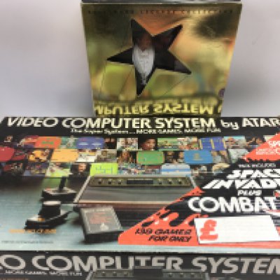 A boxed Atari games system and a 'Gone With The Wind' Ken doll (2). Shipping category C.