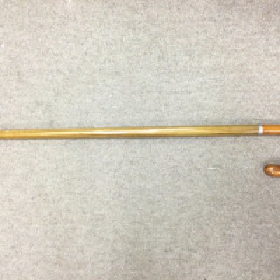 A walking stick fitted with a long glass phial. Shipping category D.