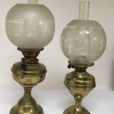 Two Victorian brass oil lamps with glass chimney and acid etched shades.