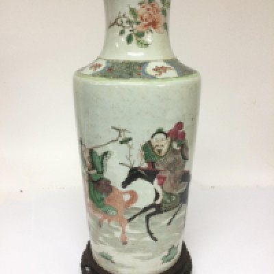 A large famille rose vase depicting figures and animals and raised on a carved hardwood base, height of vase only approx 43cm. Shipping category D.