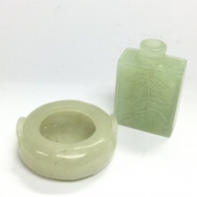 Two small jade items comprising a scent bottle and a circular vessel, bottle approx 5cm. Shipping category A.