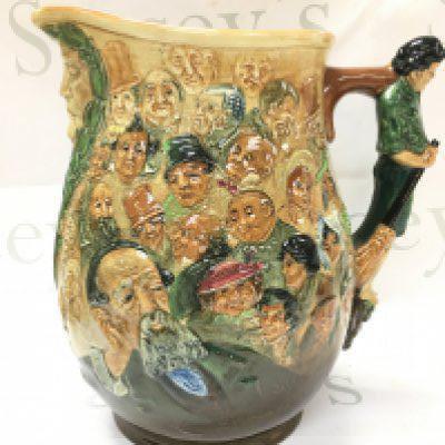 A circa 1933 Noke for Royal Doulton Charles Dickens dream jug decorated with prominent characters from his novels. Registered No. 771321. 27cm tall. No obvious damage or restoration. This lot cannot be posted