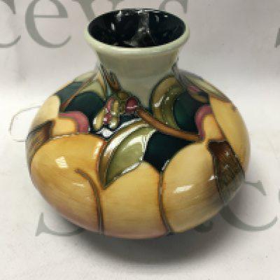 A Moorcroft vase decorated with peaches 12 cm