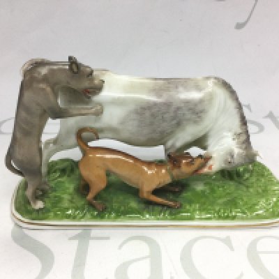 A German porcelain figural group of a bull and two hunting dogs, approx height 11.5cm. Shipping category D.