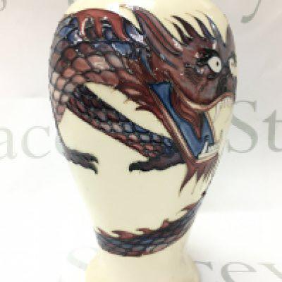 A Moorcroft pottery white ground Dragon pattern vase, circa 1987, designed by Trevor Critchlow, of baluster shape, impressed and painted factory marks to base , height approx 26cm. No obvious damage or restoration