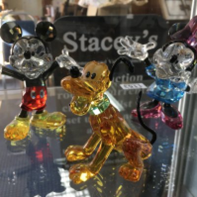 Three boxed Swarovski Disney figures including Mickey, Minnie and Pluto. No obvious damage or restoration. With certificate of authenticity