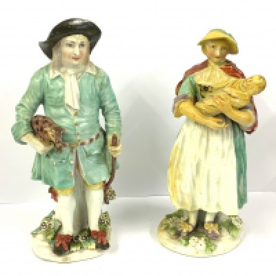 WITHDRAWN - (THESE ARE PART OF LOT 1146) A pair of Derby Tithe Pig figures, The farmer wearing holding a pig and walking stick his wife holding a baby. (D).