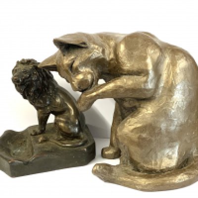 A Firth sculpture of a seated cat 20cm together with an Artisco cast lion ashtray. (D)