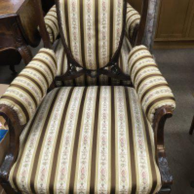 A pair of Edwardian mahogany open armchairs with upholstered back and seats on turned legs together with two other chairs .