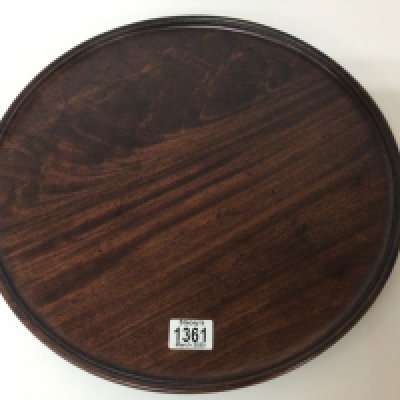 A late George III mahogany tea tray of circular shape with a moulded edge. 42cm diameter.