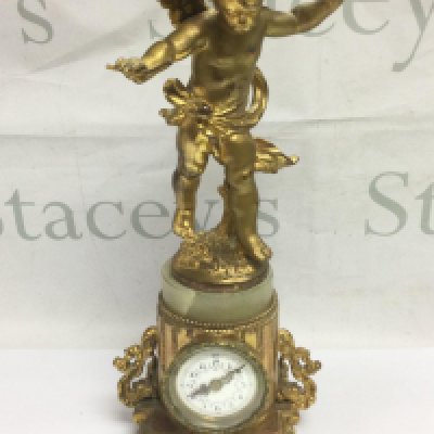 A gilt figural clock surmounted by a standing cherub, later movement, approx height 35cm. Shipping category D.